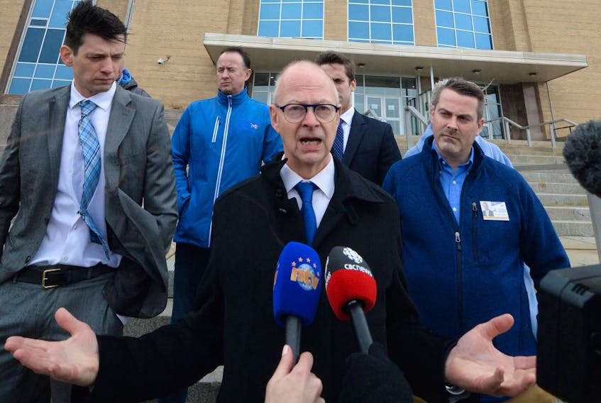 Flanked by Tory candidates for the May 16 provincial election, Progressive Conservative Leader Ches Crosbie speaks to reporters Monday on the steps of Confederation Building before hitting the campaign trail in his blue bus.