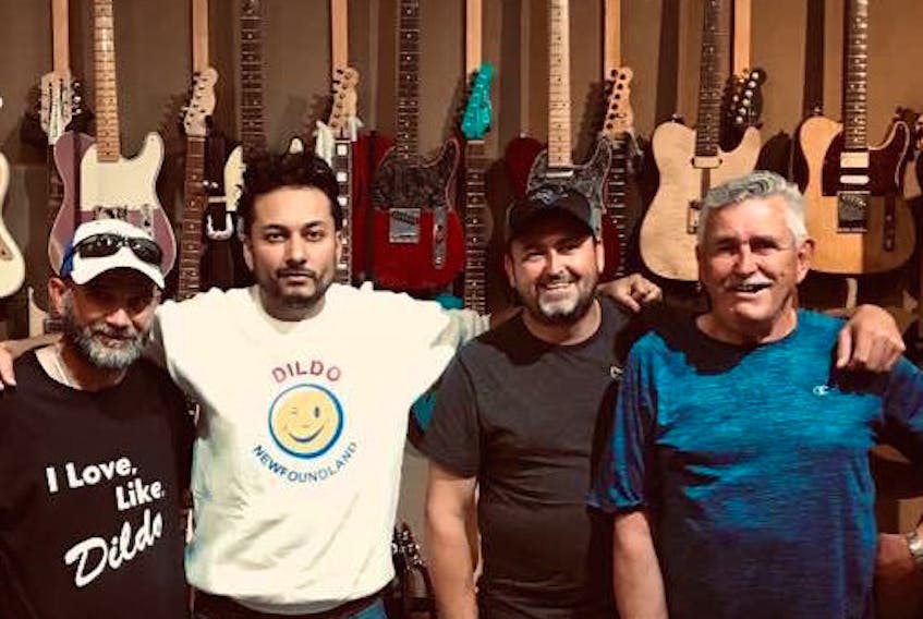 John Reid (right) was all smiles last week after recording his song, “The Dildo Song” at Comfort Cove Sound Studio in St. John’s. Also pictured are (from left) John’s nephew Dean Reid, Alberta record executive Raghav Mathur and John’s son Sheldon Reid. - Contributed