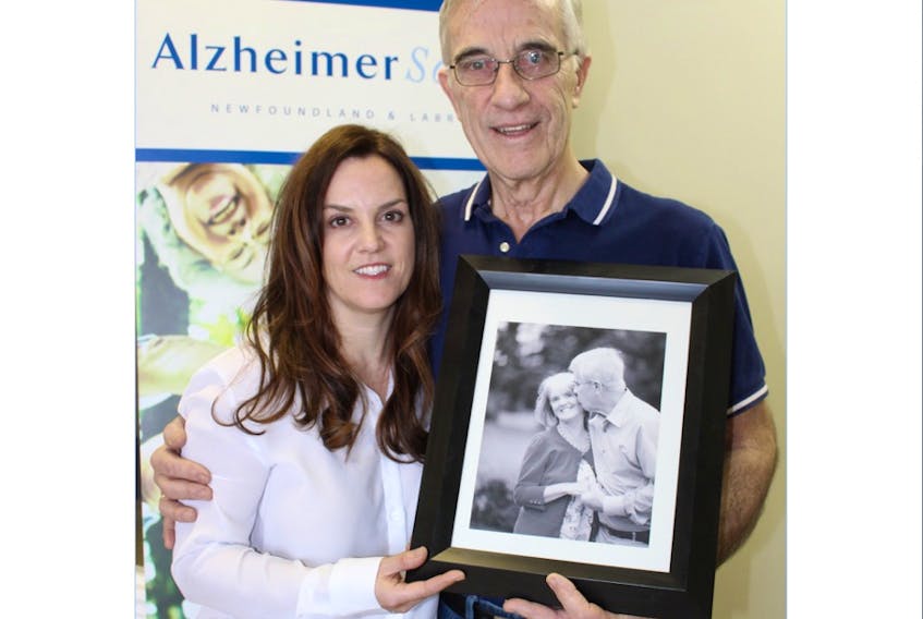 Roseanne Leonard and her dad, Blair, pose with a photo of their late mother and wife, Elizabeth, earlier this week. The pair were on hand at the Alzheimer Society of Newfoundland and Labrador sharing the story of the journey Elizabeth went through during the six years she suffered from the form of dementia.
