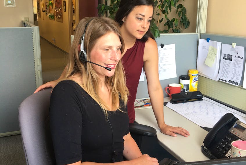 Natalie Thomas (seated) and Renee Dyer (standing) are the two dietitians answering calls to the province’s Dial-a-Dietitian 811 HealthLine service.