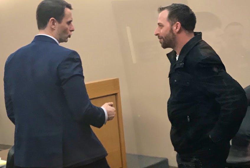 Benji Barnes (right) talks with his lawyer, Stephen Orr, after the adjournment of his trial in provincial court in St. John's Friday morning. Barnes' trial will resume March 5.