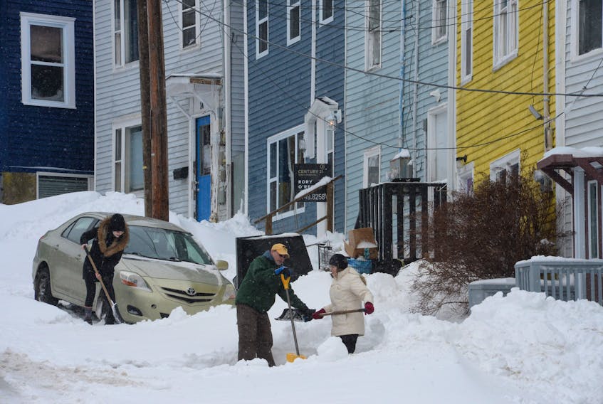 Neighbours on Chapel Street in St. John’s were out to shovel during a lull in Wednesday’s snow storm Here (from left) Sarah Baldwin, Charlie Langmead and Faye Squires work to dig out their vehicles.