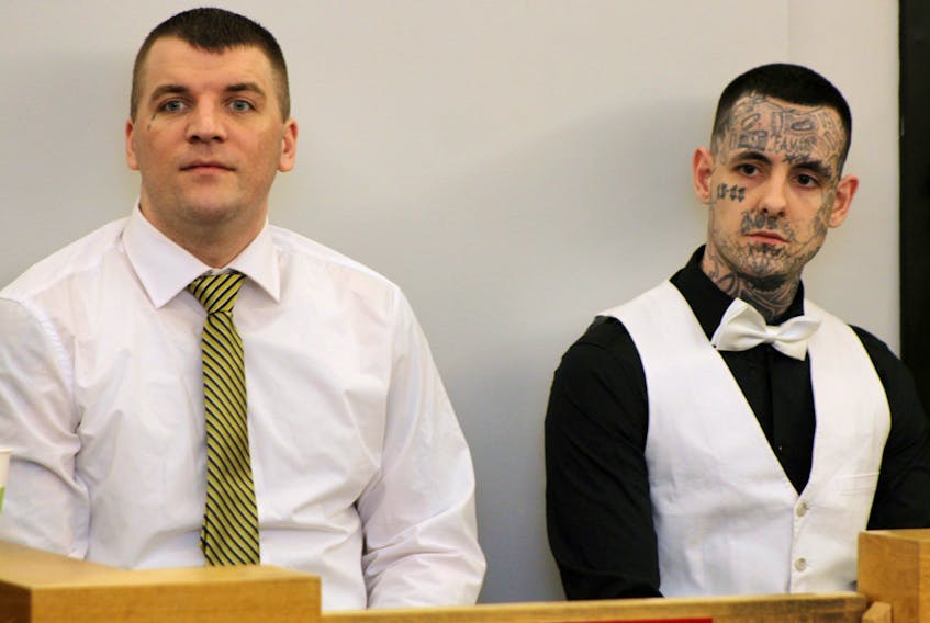 Gary Hennessey (left) and Mitchell Nippard sit in the prisoner’s dock in provincial court in St. John’s Wednesday afternoon, waiting for Judge Mike Madden to arrive and deliver his verdict in a series of violent home invasions.