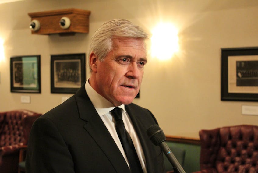 Premier Dwight Ball speaks to reporters Thursday outside the House of Assembly.