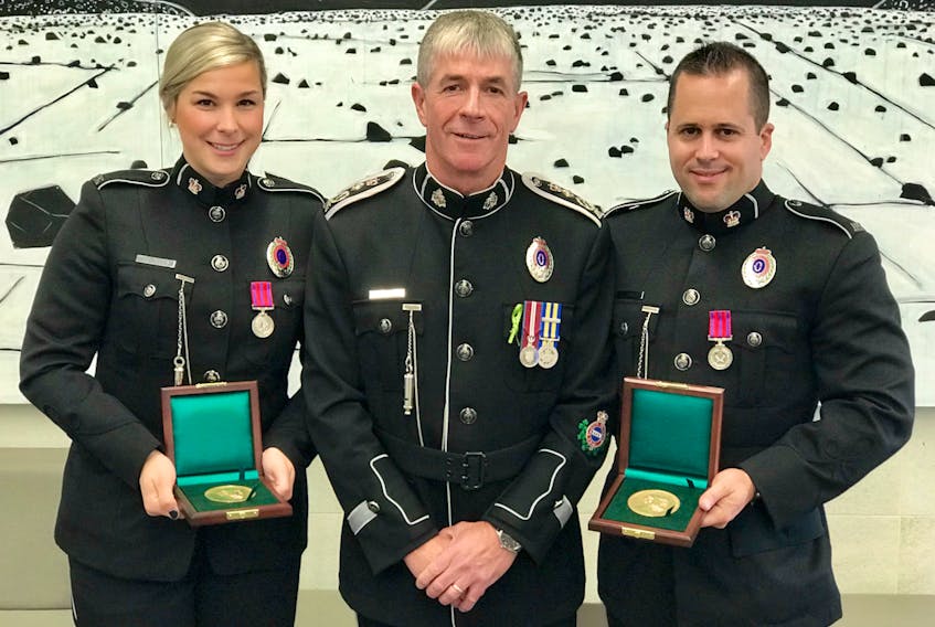Royal Newfoundland Constabulary Chief Joe Boland (centre) with medal recipients Const. Stephanie Myers and Const. Charley Torres.