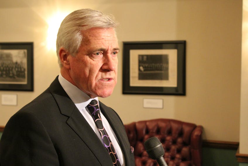 Premier Dwight Ball speaks to reporters Tuesday outside the House of Assembly.