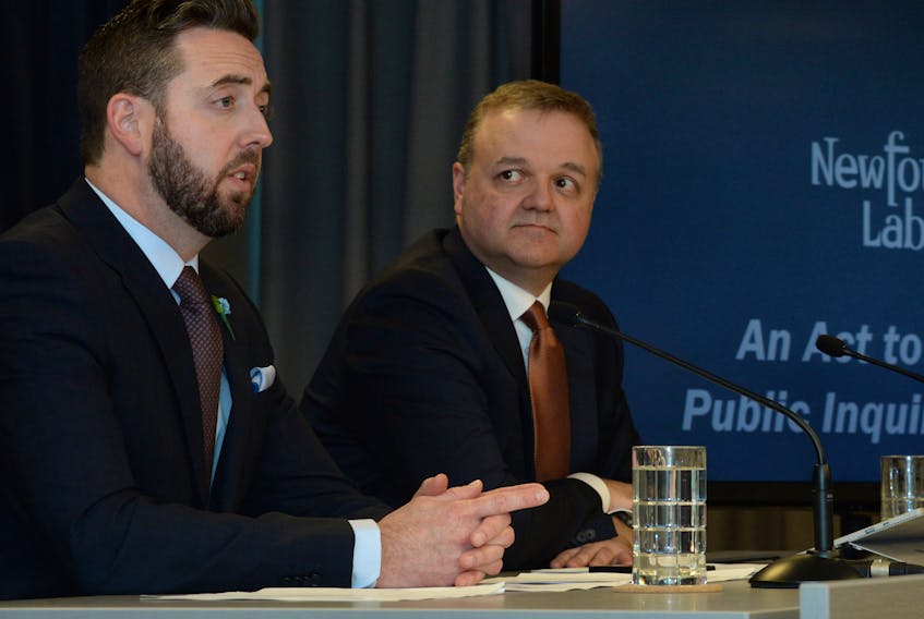 Justice Minister Andrew Parsons (left) and deputy justice minister Todd Stanley speak about proposed amendments to the Public Inquiries Act at the Confederation Building on Tuesday afternoon.