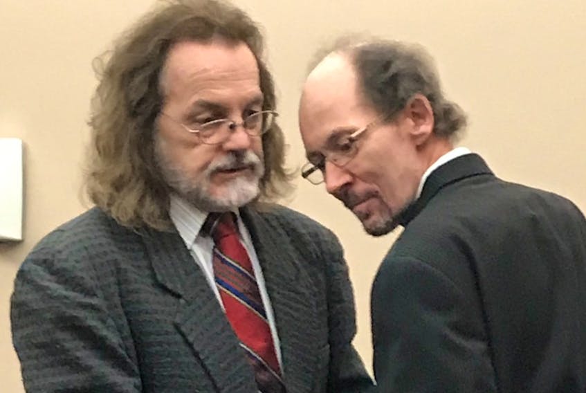Kenneth Harrisson (right) speaks with his lawyer, Bob Buckingham, before leaving provincial court in St. John's after his trial wrapped up Monday morning.
