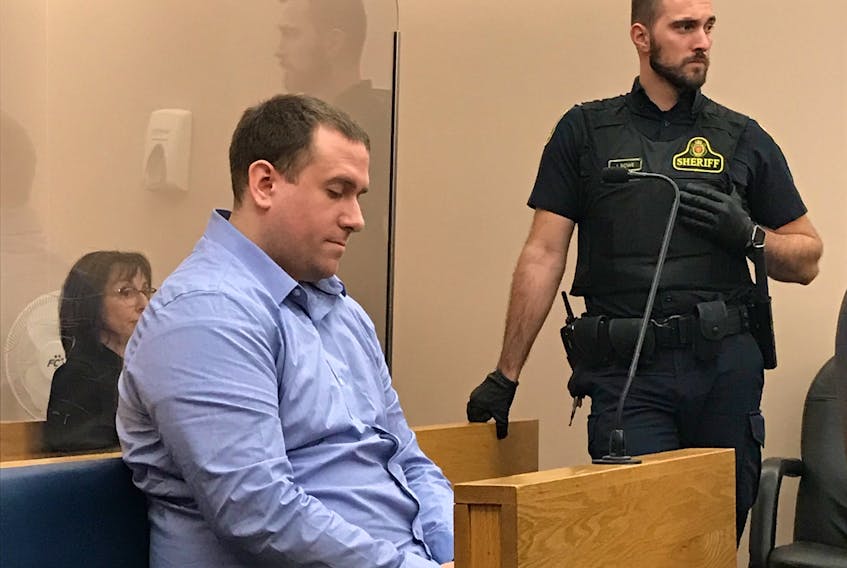 Brandon Phillips sits in a provincial courtroom in St. John's Tuesday morning, where he pleaded guilty to two charges related to the possession of a mix of heroin and fentanyl. Behind him is Linda McBay, wife of Larry Wellman, whose murder Phillips was convicted of last fall.