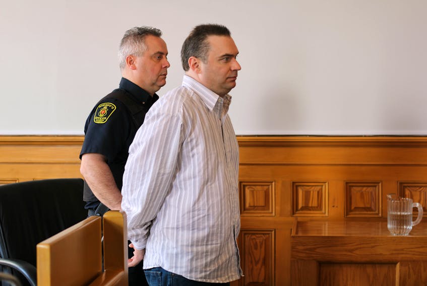 Jason King is escorted out of the courtroom at Newfoundland and Labrador Supreme Court in St. John’s Wednesday morning.