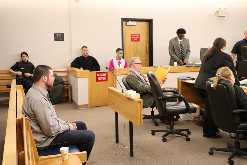 The courtroom in St. John’s Thursday where a trial is taking place for Tyler Donahue, 24 (sitting, at left), (in prisoners’ dock, from left) Gary Hennessey, 33, Mitchell Nippard, 26, and Abdifatah Mohamed, 28, who face numerous charges in connection with four home invasions in February 2017.