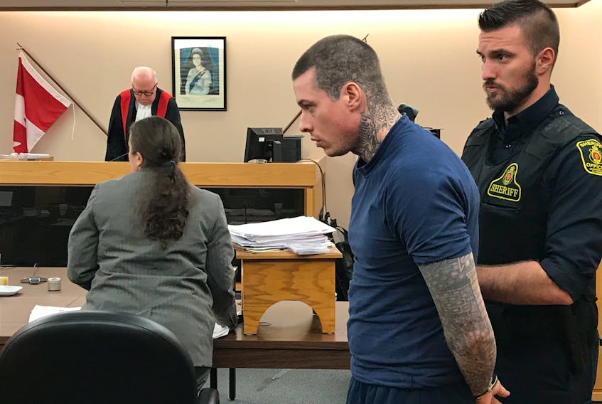 A sheriff’s officer prepares to escort Colin Wheeler from the courtroom after he was sentenced to about 13 months in prison for a range of crimes he committed while an inmate at Her Majesty’s Penitentiary between April and October of this year. Lawyer Shanna Wicks is shown in the background, as well as Judge Mark Pike on the bench.