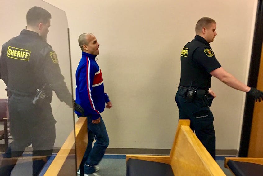 Ramon Hernandez walks out of the courtroom in provincial court in St. John’s with sheriff’s officers Thursday after he was freed from jail.