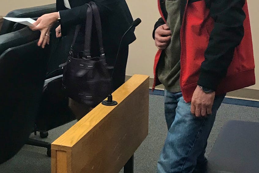 Randolph (Randy) Douglas Dawe, 54, prepares to leave provincial court with his lawyer, Candace Summers, Wednesday morning.