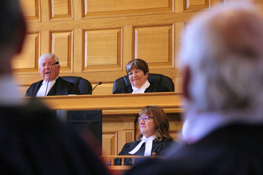 Deborah Fry (top, right) smiles during her swearing-in ceremony as the province's chief justice at Newfoundland and Labrador Supreme Court in St. John's Monday morning. Administering Fry's oaths was former chief justice Derek Green, who stepped down at the end of 2017.