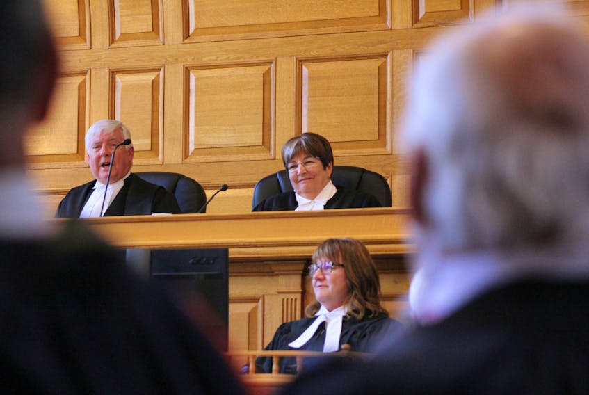 Deborah Fry (top, right) smiles during her swearing-in ceremony as the province's chief justice at Newfoundland and Labrador Supreme Court in St. John's Monday morning. Administering Fry's oaths was former chief justice Derek Green, who stepped down at the end of 2017.