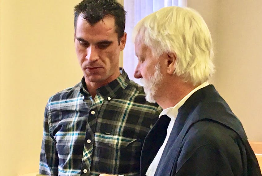 Steven Ryan Mercer (left) speaks to his lawyer, Randy Piercey, during a break in proceedings in Mercer's trial at Newfoundland Supreme Court in St. John's Wednesday.
