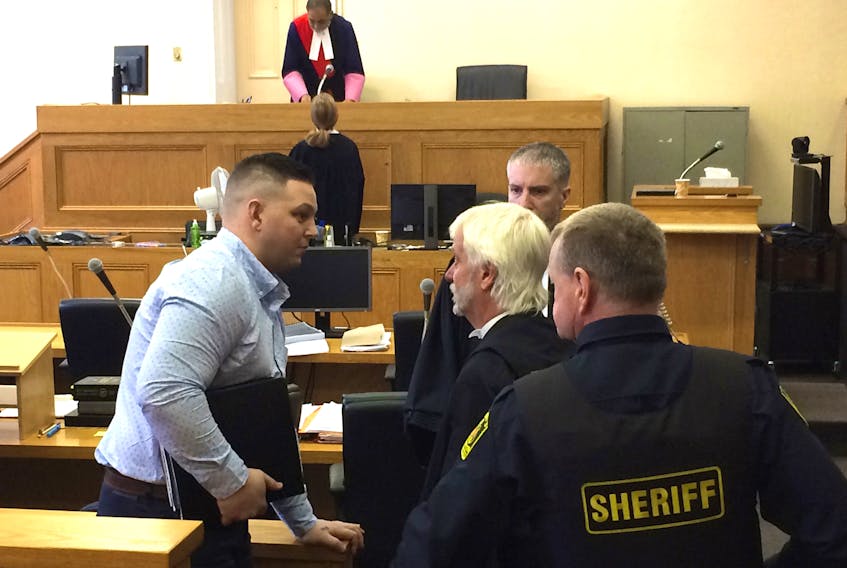 Craig Pope (left) speaks with defence lawyer Randy Piercey as his second-degree murder trial is adjourned in Newfoundland and Labrador Supreme Court in St. John’s Wednesday. Justice Vikas Khaladkar (background) is presiding over the jury trial, which will resume Thursday.