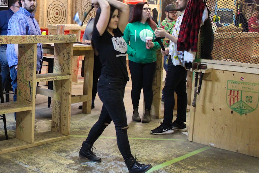 Kelsey Vivian of St. John’s competes in the Jack Axes league play, and is one of several players who have become hooked on axe throwing.