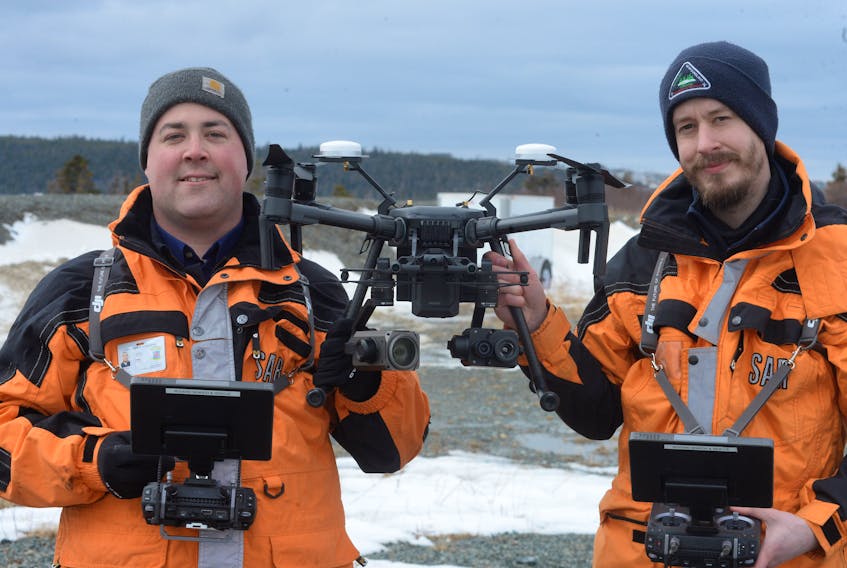 Rovers Ground Search and Rescue members Paul French (left) and Robin Murray hold the Rovers’ new DJI Matric 210 RTK UAV drone Wednesday at the group’s headquarters in Paradise.