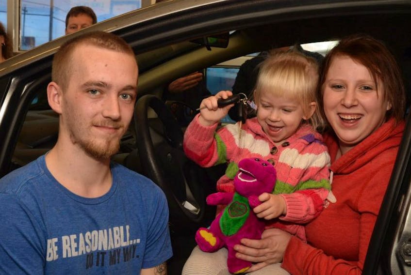 Christine Ryall, 23, and her daughter, Alayah Ryall-Wells, 2, were presented the keys to a refurbished 2014 Ford Fiesta along with a few extra Christmas gifts. Her partner, Jeffrey Wells, 22, was along for the presentation.