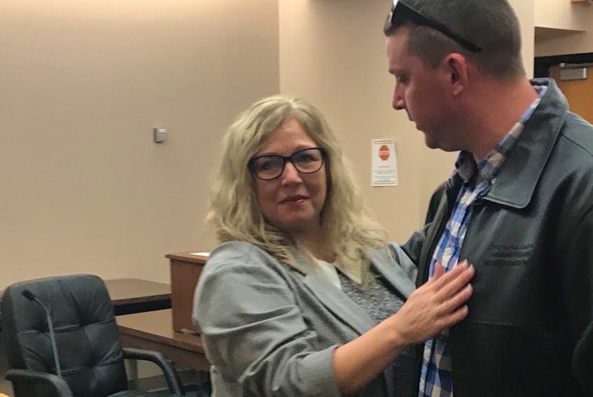 A joyful Debbie McGrath hugged her loved ones in the courtroom Monday after she was acquitted of charges of fraud, forgery and theft.