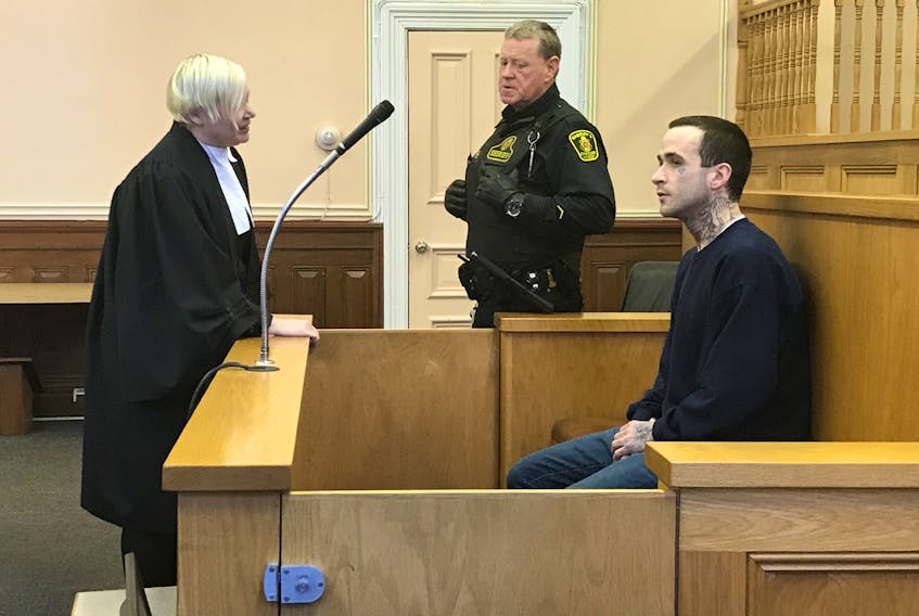 Jason Earle, 25, speaks to his lawyer, Jennifer Curran, prior to his sentencing in Newfoundland and Labrador Supreme Court in St. John's Monday afternoon.