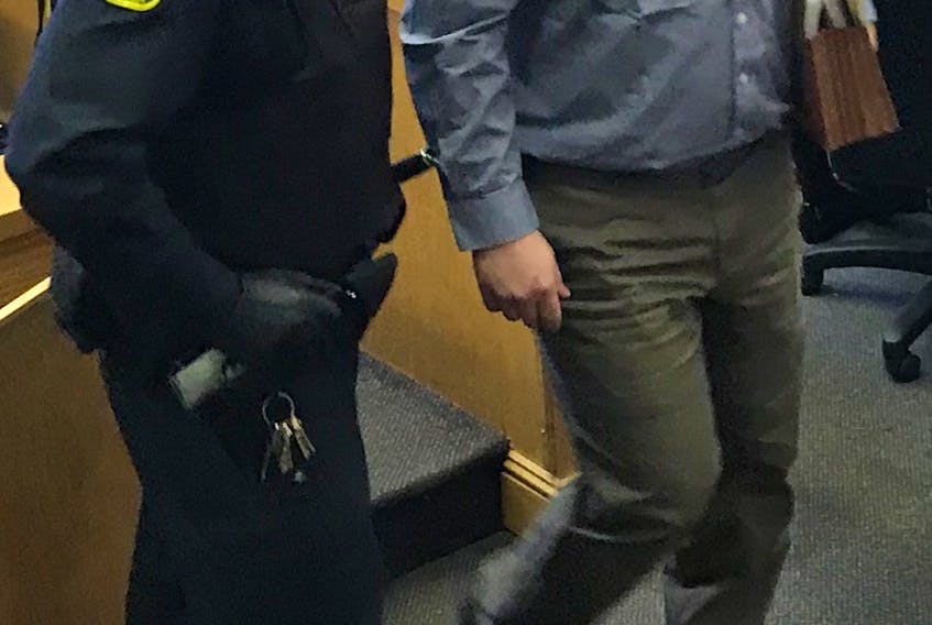 Trent Butt is escorted from the courtroom during a break in proceedings Thursday. The jury in his murder trial is sequestered to deliberate a verdict.