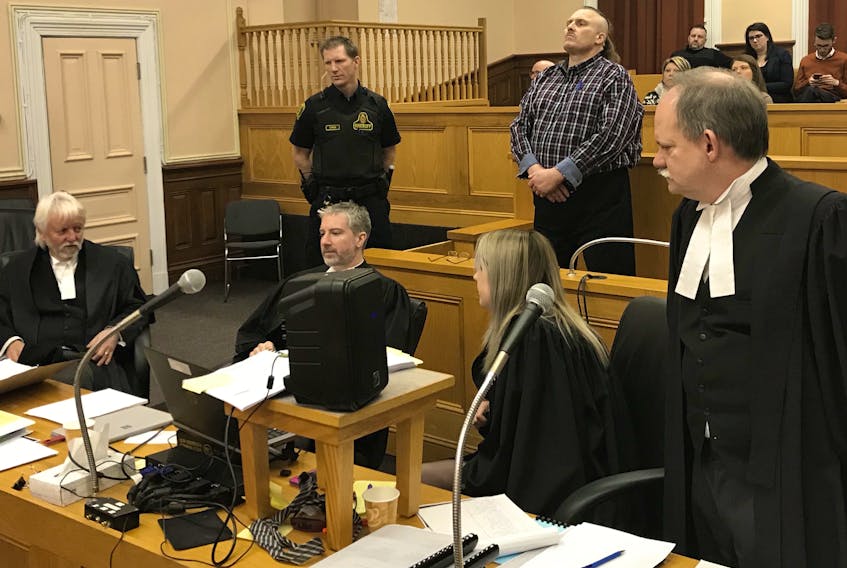 The courtroom on Friday, before the start of Day 10 of Allan Potter’s murder trial in St. John’s. Sitting (from left) are defence lawyers Randy Piercey and Jon Noonan, and prosecutors Erin Matthews and Sheldon Steeves. Behind them, Potter stands in the dock, awaiting Justice Garrett Handrigan and the jury.