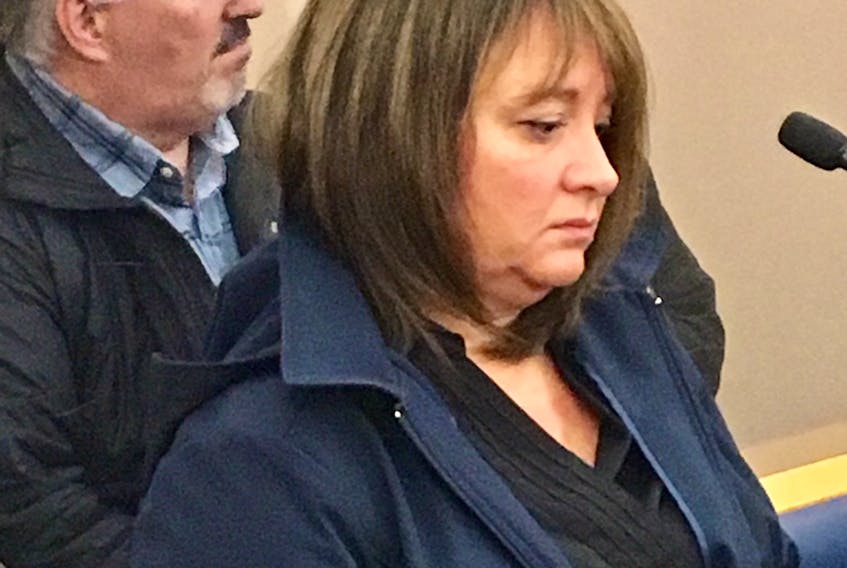 Leah Chaulk, with her husband Doug sitting behind her at provincial court in St. John’s Thursday, was given a conditional sentence for defrauding Backyard Contractors, where she worked for more than 15 years.
