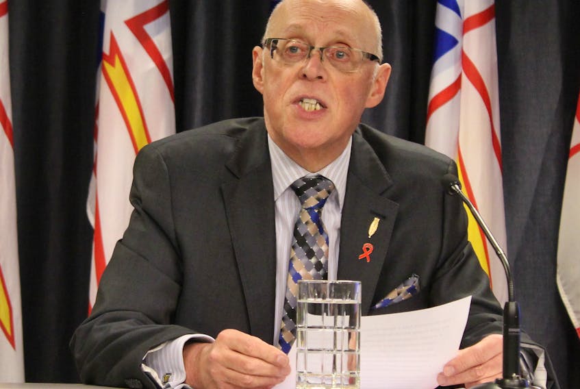 Health Minister John Haggie outlines the new health care legislation on Tuesday.