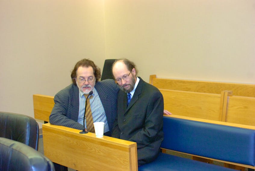 Kenneth Harrisson (right) speaks with his lawyer, Bob Buckingham, prior to the start of proceedings in Harrisson’s trial at provincial court in St. John’s Tuesday.
