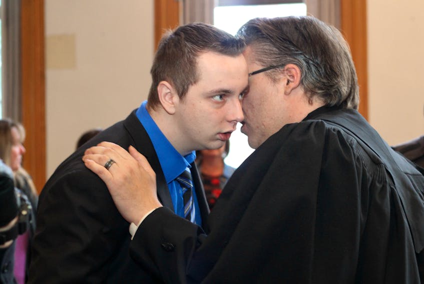 Jesse Lewis (left) speaks with his lawyer, Mark Gruchy just after being acquitted of five charges related to a shooting in Avondale last year.