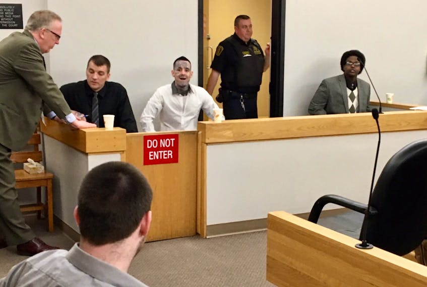 The trial for four men suspected in four violent home invasions continued Monday in provincial court in St. John’s. Lawyer Derek Hogan (left) spoke to his client, Gary Hennessey, prior to the start of proceedings, while Tyler Donahue (back on), Mitchell Nippard and Abdifatah Mohamed look on.