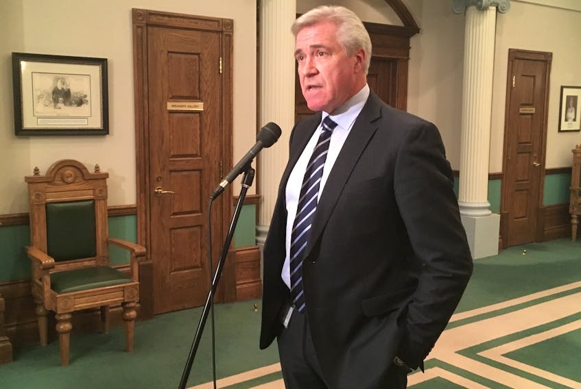 Premier Dwight Ball takes questions from reporters outside the House of Assembly Tuesday afternoon.