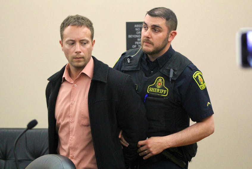 A sheriff's officer takes Ray Newman into custody after he was sentenced to 60 days in jail in St. John's Wednesday afternoon for assaulting his ex-girlfriend.
