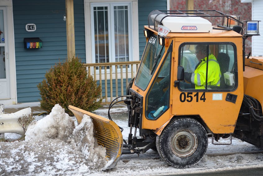 A City of St. John’s snowclearing crew member clears and salts a section of sidewalk on Empire Avenue in the Rabbittown area on Wednesday morning.