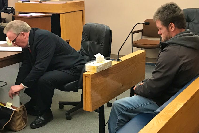 Richard Rees, 35, sits behind his lawyer, Derek Hogan, in provincial court during a break in his trial Tuesday. Rees is accused of sexually assaulting two young teenage girls on a centre-city path last spring.