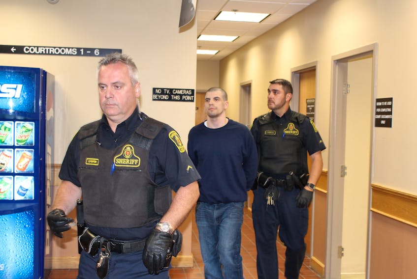 Justin Jordan is escorted out of Courtroom No. 7 back to the holding cells by sheriff’s officers in provincial court in St. John’s Monday after he was sentenced for stabbing another inmate, accused murderer Trent Butt.