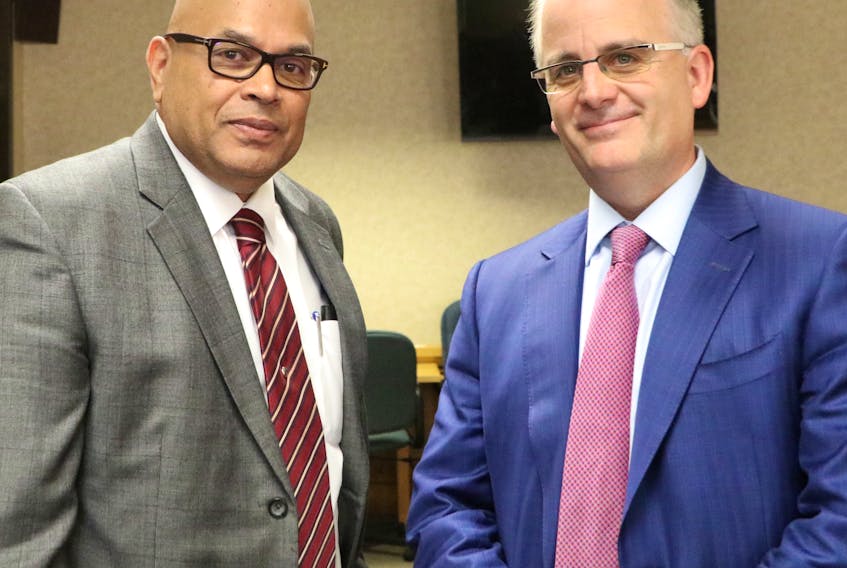 Lawyers Ernest Gittens (left) and Barry Mason represent the Atlantic Provinces Trial Lawyers Association at the insurance review public hearings being carried out by the Public Utilities Board (PUB).