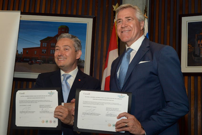 Newfoundland and Labrador Premier Dwight Ball (right) and federal Infrastructure and Communities minister Francois-Philippe Champagne sign a bilateral agreement at St. John’s City Hall Monday morning. Under the umbrella agreement $555.8 million will be made available to Newfoundland and Labrador between 2018-28 for community infrastructure projects.