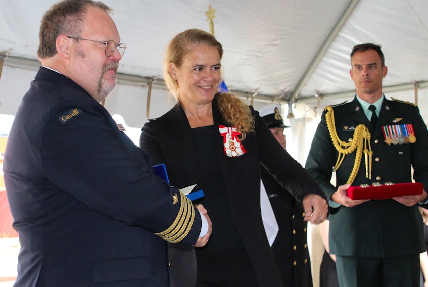Gov. Gen. Julie Payette presents Capt. Fergus Francey with a first bar award during a ceremony in which four members were presented with exemplary service medals and awards Wednesday at the Canadian Coast Guard Atlantic regional headquarters in St. John’s
