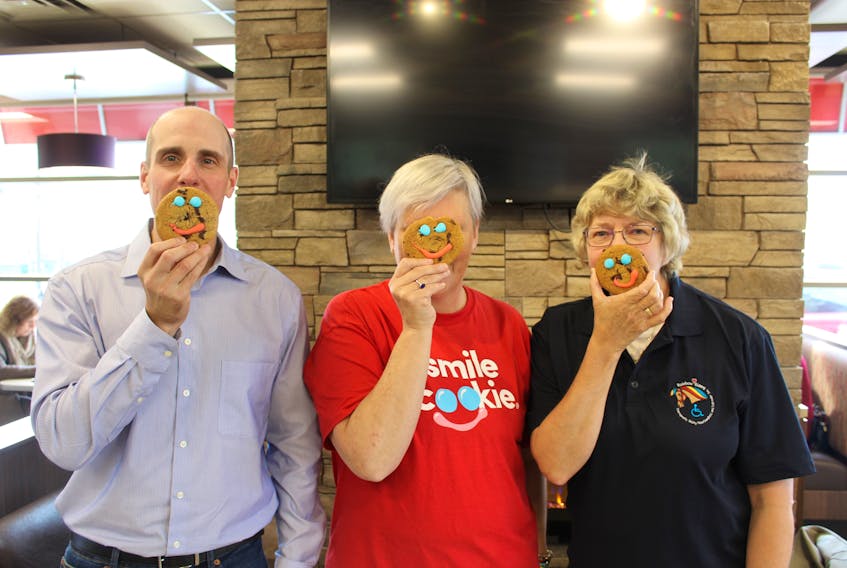 On hand to promote the Smile Cookie fundraiser were Ken Hopkins (left), executive director of the School Lunch Association, Tim Horton franchisee Marlene Van de Wiel at her Ropewalk Lane location and Margaret (Muggs) Tibbo, board member for Rainbow Riders.