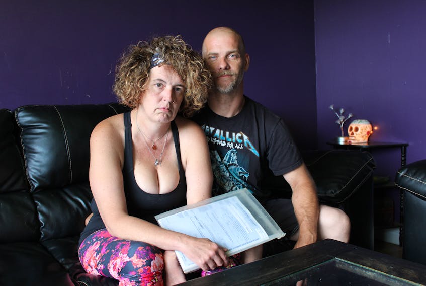 Paula Tucker and Michael Tucker in their home in Carbonear. They want to share their story of unexpected bills and accounts they weren’t aware existed.