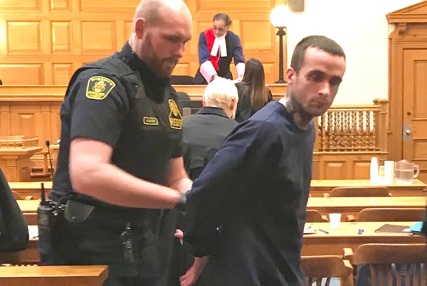 Sheriffs handcuff Jason Earle, 25, before escorting him out of a St. John's courtroom once his sentencing hearing wrapped up Thursday.