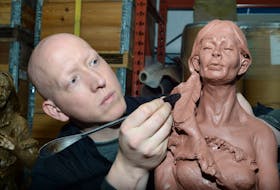Morgan MacDonald works on the clay statue of Demasduit, one of three he is completing as a personal project to help tell and commemorate the history of the Beothuk people.