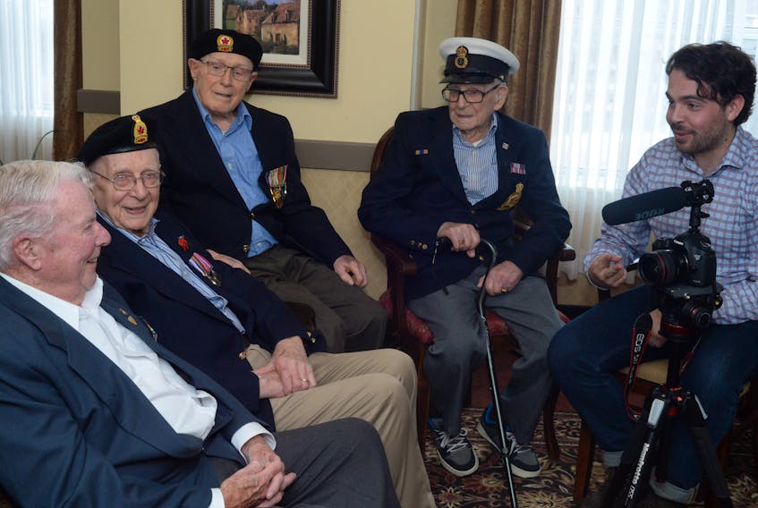 Eric Brunt (right), a 26-year-old filmmaker from British Columbia, speaks with Second World War veterans in St. John’s Monday. (From left) are Joe Prim, 92, Merchant Navy (1943-1945); James Steele, 94, 59th Heavy Artillery Regiment (1943-1945); Elmo Baird, 99, Royal Airforce (1939-1945); and Rod Deon, 97, Canadian Navy onboard the HMCS Ottawa II and who also saw action on D-Day in the English Channel (1942-1945).