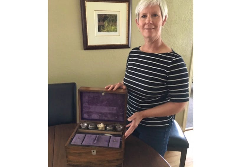 Laura Lang of Victoria, B.C., displays a wooden writing box that she found in her late sister’s home four years ago. Many of the items found inside have links to St. John’s, and she hopes someone will know more.