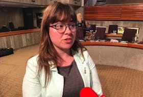 Coun. Maggie Burton speaks with reporters from VOCM and The Telegram following the St. John’s city council meeting Monday night. Burton said she’s concerned there may be some confusion over heritage regulations versus building codes, after a recent news article about the Masonic Temple.