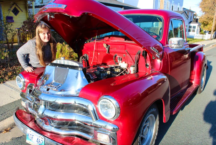 Kiera DeFoort proudly displays the 1954 Chevy pickup that was restored by her grandfather, Dennis DeFoort, who left it to the 12-year-old when he recently died.